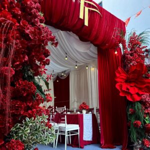 Rạp ăn hỏi tại nhà nhung đỏ cổng monogram TT vàng trụ hoa đỏ
