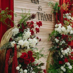 Lễ ăn hỏi Vân Thành backdrop vải kem xếp nếp chữ tên đen vòng tre vàng hoa hồng đỏ trắng